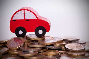 toy auto driving on pesos