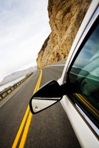 Driving around a curve on between beach and cliffs in Mexico