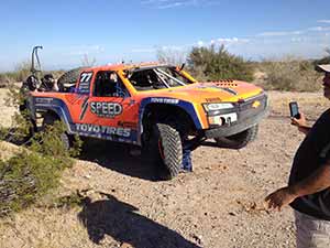 Person photoing Baja 1000 truck taking a break