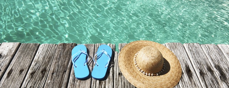 Shoes & Hat sitting next to a pool in Mexico