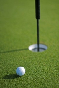 Golf Ball next to the Hole