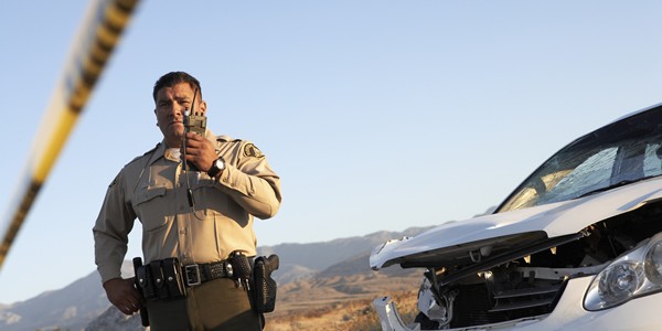 Police officer calling in an accident in a Mexico desert