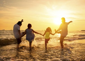 Family playing in the water, holding hands on Beach Mexico