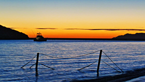 Boat in bay in San Carlos, Mexico at sunset