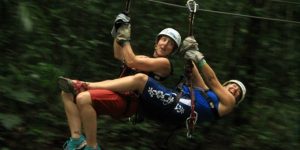 Women riding zip line in Puerto Vallart Mexico