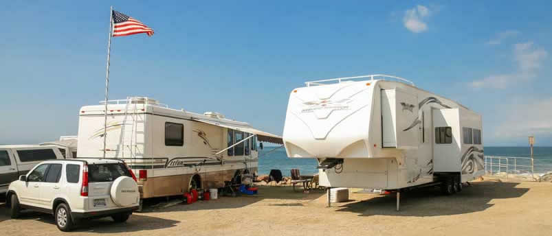 two RVs parked on the beach in Rocky Point