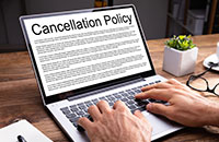 Laptop with Cancellation Policy on Screen