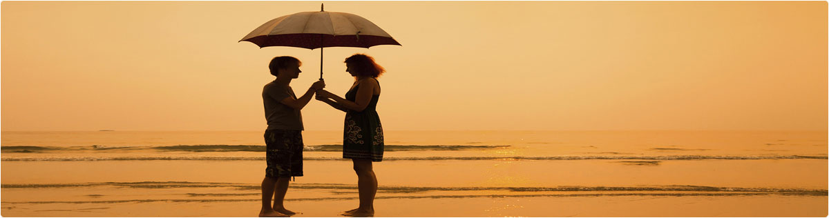 Couple on Beach with Umbrella
